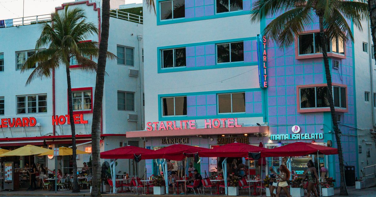 Ocean Drive's hotels and palm trees at dusk on Miami's South Beach